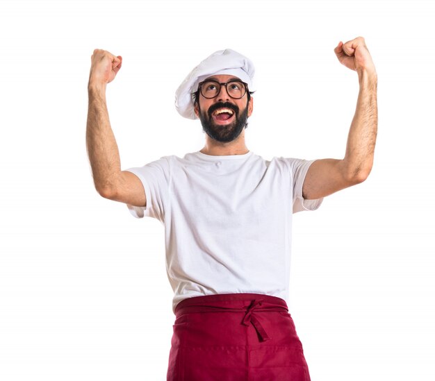 Chef faisant geste de la victoire sur fond blanc