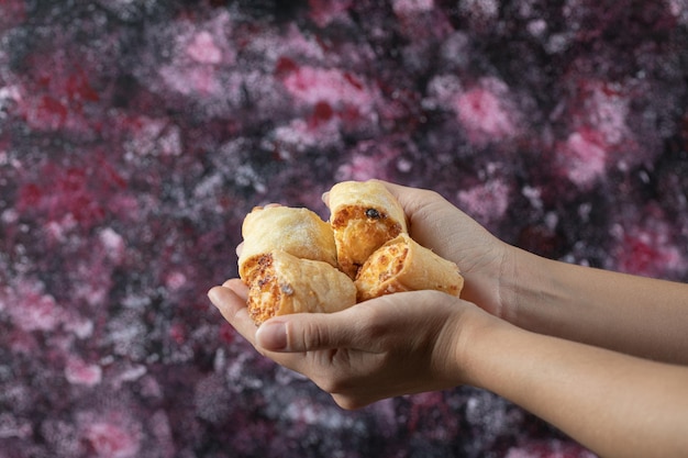 Un chef tenant des biscuits au beurre à portée de main.