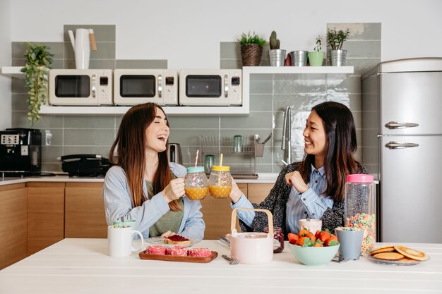 Chéri girlfiends appréciant des boissons au petit déjeuner