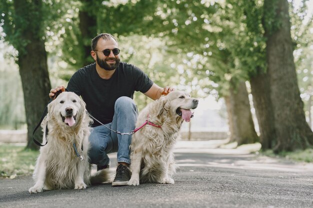 Chien-guide aidant un aveugle dans la ville. Beau mec aveugle se repose avec golden retriever dans la ville.