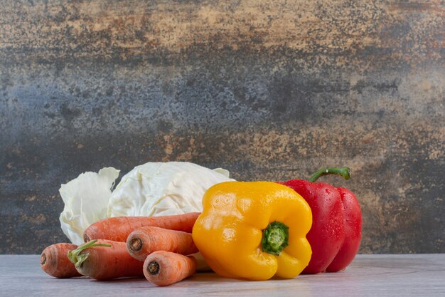 Chou, carottes et poivrons sur table en pierre. Photo de haute qualité