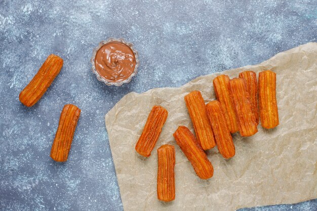 Churros dessert mexicain traditionnel avec du chocolat, vue de dessus