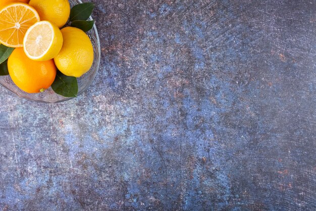 Citrons jaunes frais placés sur la pierre.