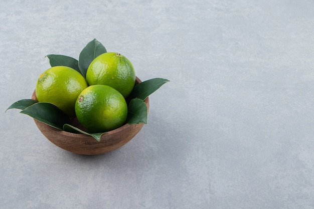 Citrons mûrs frais dans un bol en bois