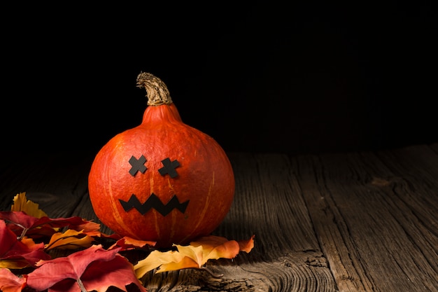 Photo gratuite citrouille d'halloween effrayant et feuilles