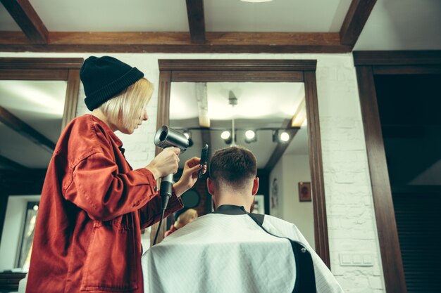 Client pendant le rasage de la barbe dans le salon de coiffure.