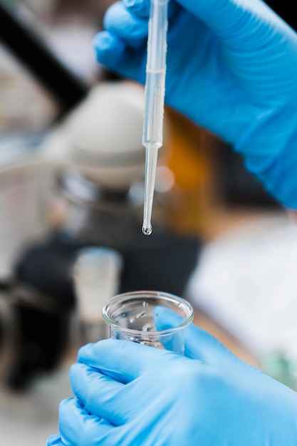 Close-up hand holding pipette