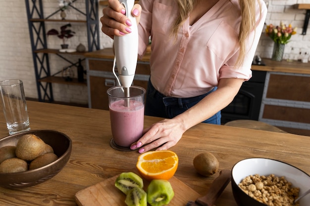 Close up hand making smoothie