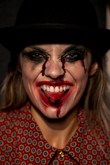Close-up portrait de femme clown tirant sa langue