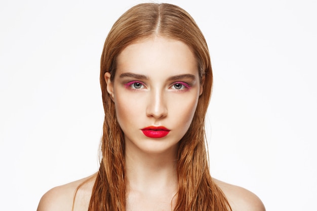 Close-up portrait of young woman with light make up.