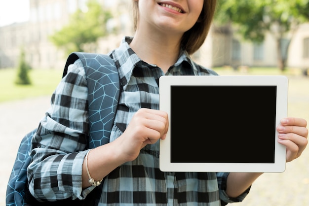 Close up school girl holding tablet