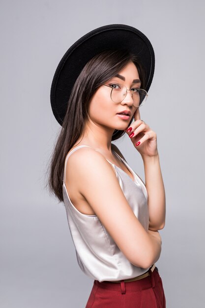 Close up side portrait of smiling summer asian woman with funky black hat and sunglasses