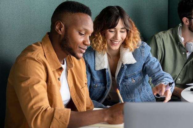 Photo gratuite collègues étudiant à partir de cahiers pendant la session d'étude