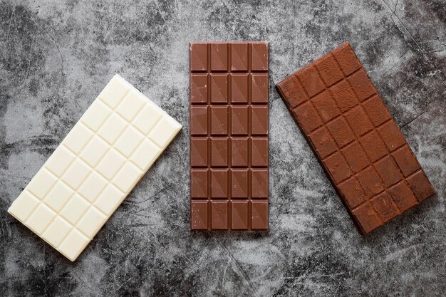 Composition de chocolat créatif à plat sur fond sombre