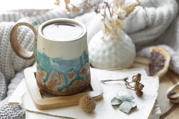 Composition confortable avec une tasse de livres de thé et un élément tricoté