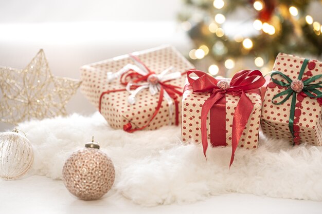 Composition festive de Noël avec trois coffrets cadeaux sur fond de bokeh se bouchent.