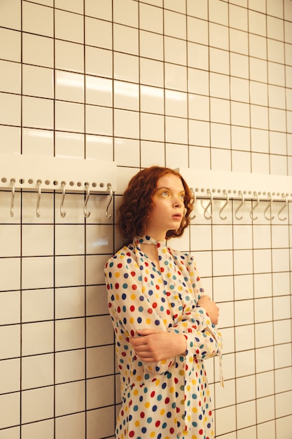 Concentré jeune femme rousse bouclée debout dans un café