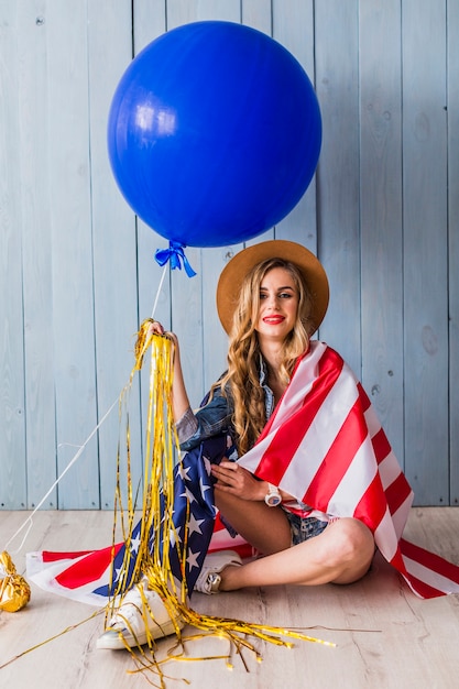 Concept de fête de l&#39;indépendance des États-Unis avec assis femme et ballon