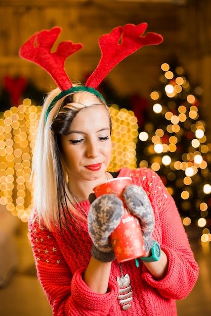 Concept de Noël avec une femme blonde à boire