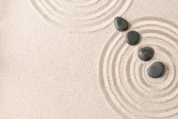 Concept de santé et bien-être de fond de sable de pierres zen