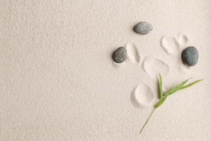 Photo gratuit concept de santé et de bien-être de fond de sable de pierres zen