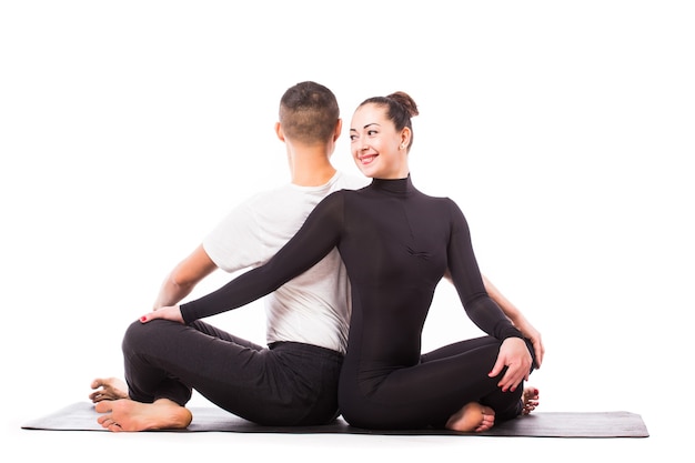 Concept de yoga en couple. Jeune couple en bonne santé en position d'yoga sur fond blanc