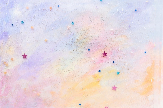 Confettis étoiles scintillantes sur fond aquarelle pastel abstrait coloré
