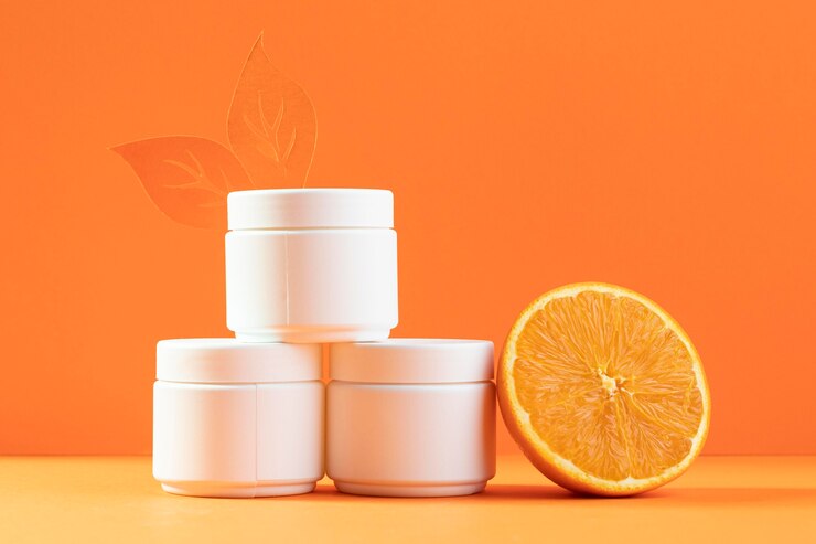 Photo gratuit contenant de crème pour le visage à l'orange