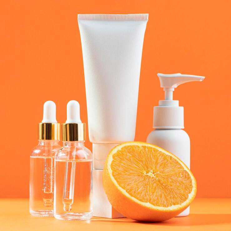 Photo gratuit contenants de crème blanche à l'orange