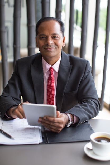 Content Indian Business Man Working in Cafe