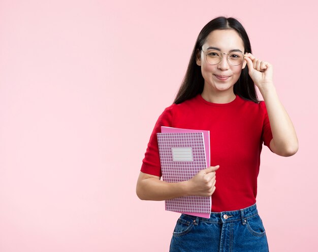 Copiez l'espace féminin avec des lunettes et un livre