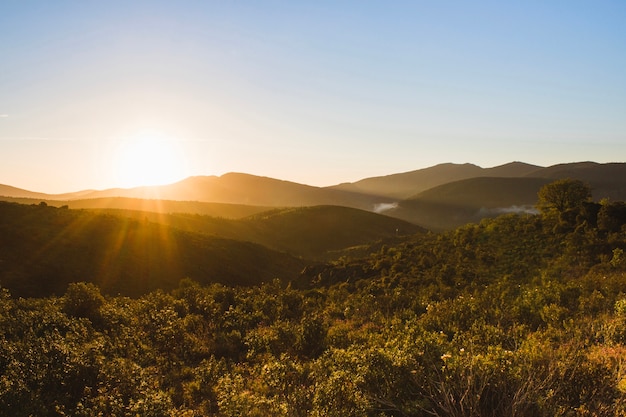 Coucher de soleil sur une campagne vallonnée