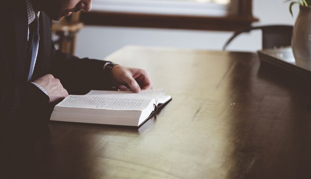 Coup de mise au point peu profonde d'une personne lisant un livre arabe