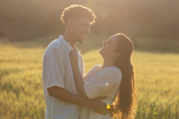 Coup moyen couple heureux étreignant à l'extérieur