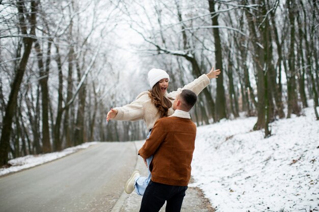 Photo gratuite coup moyen couple heureux l'heure d'hiver