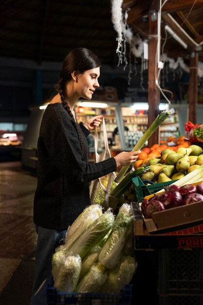 Coup moyen femme achetant des légumes