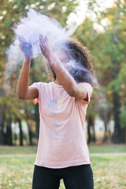 Coup moyen de femme créant de la poussière bleue