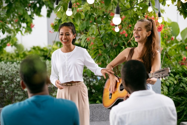 Coup moyen femme heureuse jouant de la guitare