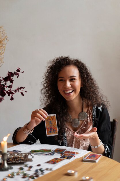 Coup moyen femme lisant le tarot à table