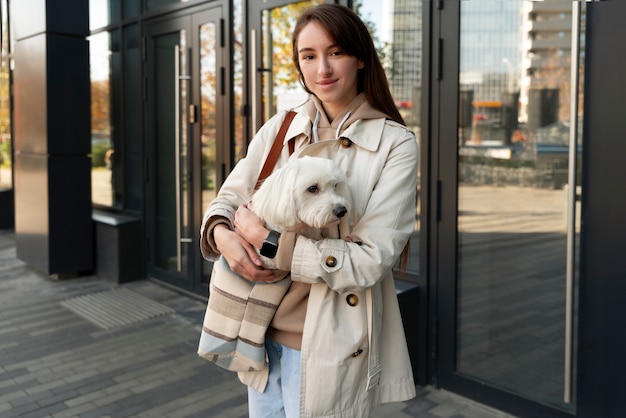 Coup moyen femme portant un chiot dans un sac