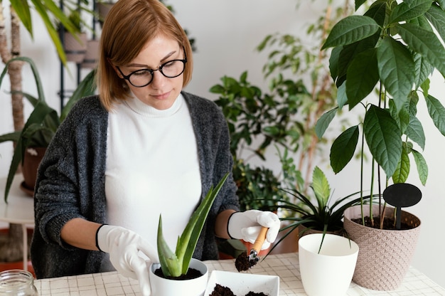 Coup moyen femme travaillant avec des gants