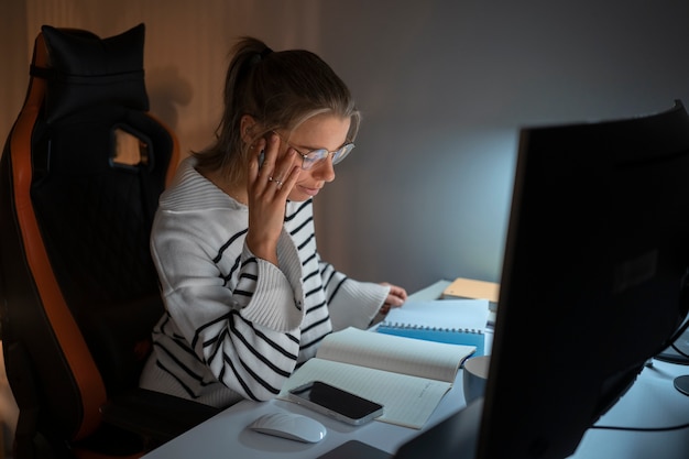 Coup moyen femme travaillant tard dans la nuit