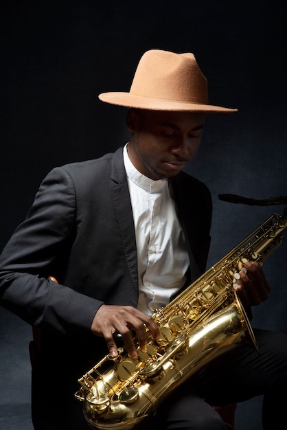 Coup moyen homme talentueux tenant un saxophone