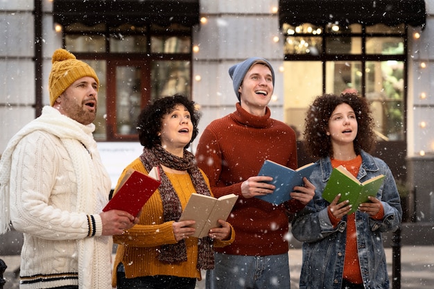 Coup moyen de personnes chantant des chants de noël