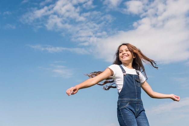 Coup moyen petite fille aux cheveux longs souriant