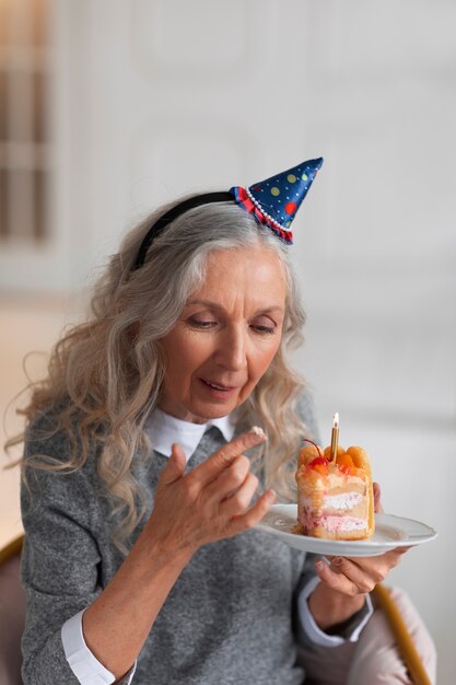 Coup moyen vieille femme tenant un gâteau