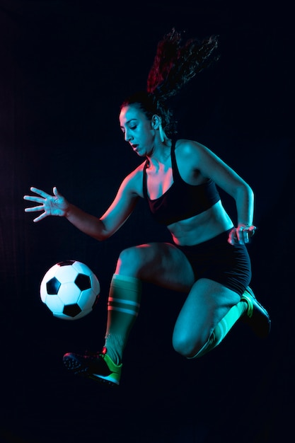 Photo gratuite coup plein fit femme jouant au football