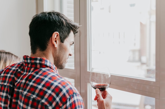 Photo gratuite couple avec du vin à la fenêtre