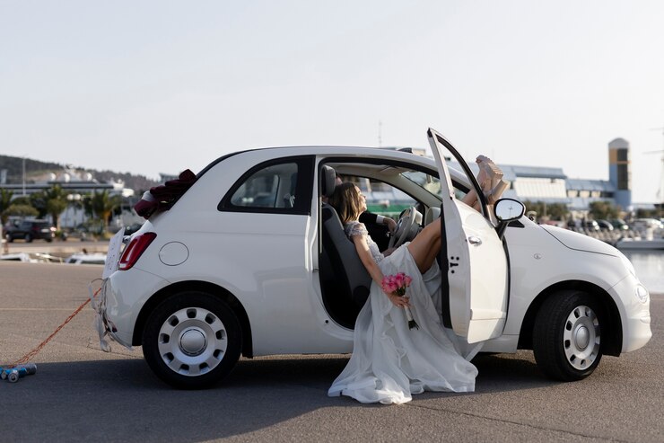 Photo gratuit couple juste marié à l'intérieur d'une petite voiture