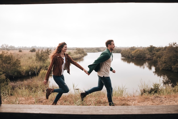 Couple latéral en cours d'exécution à côté d'un étang